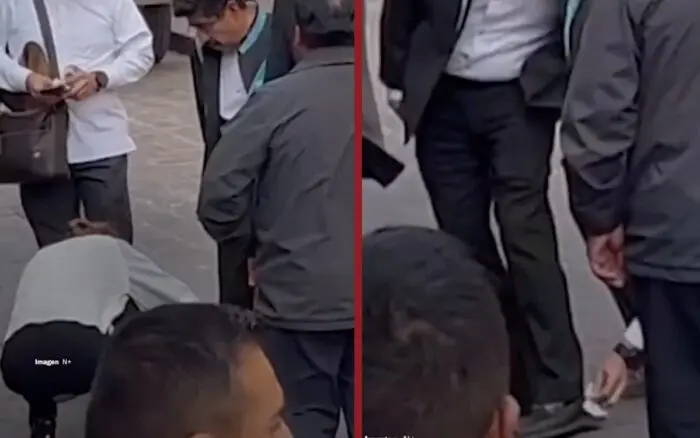 Funcionarios se agachan para limpiarle los zapatos a Hugo Aguilar